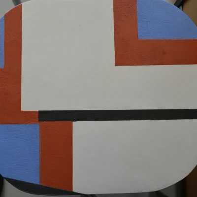Motifs géométriques sur l'assise du tabouret en béton ciré