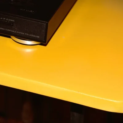 Gros plan sur la texture et la finition jaune du plateau en béton ciré
